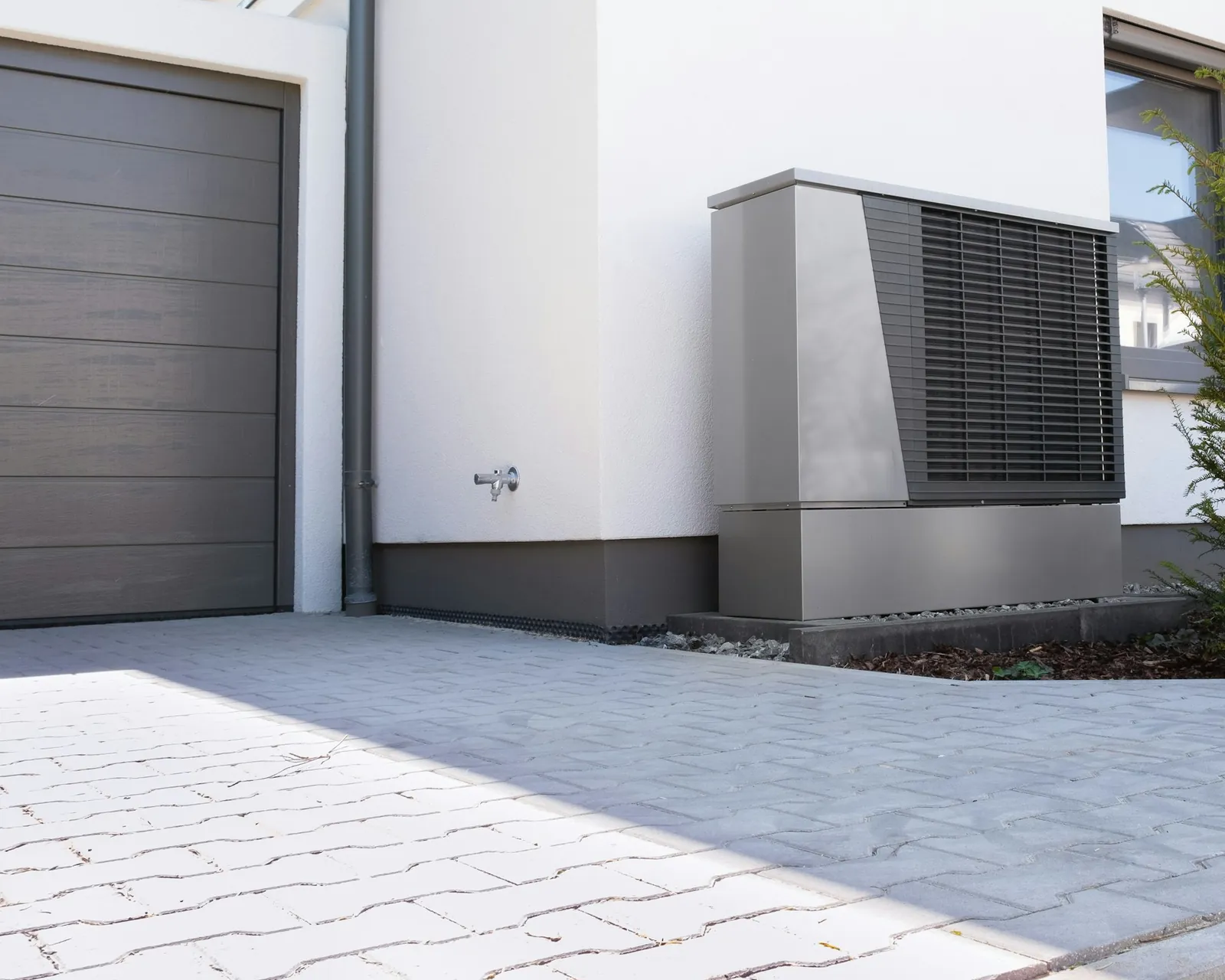 A heat pump outside a modern home