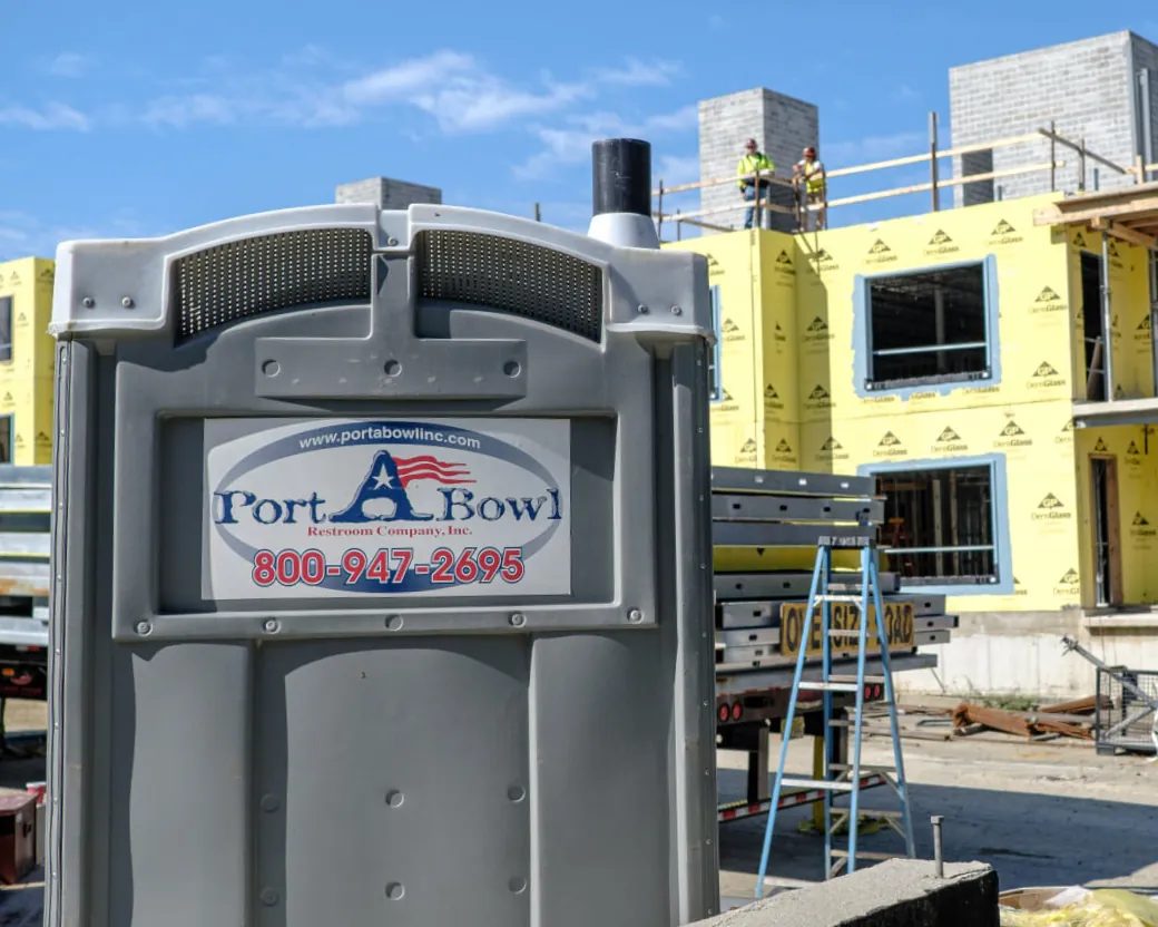 A Port A Bowl portable restroom on an active construction site
